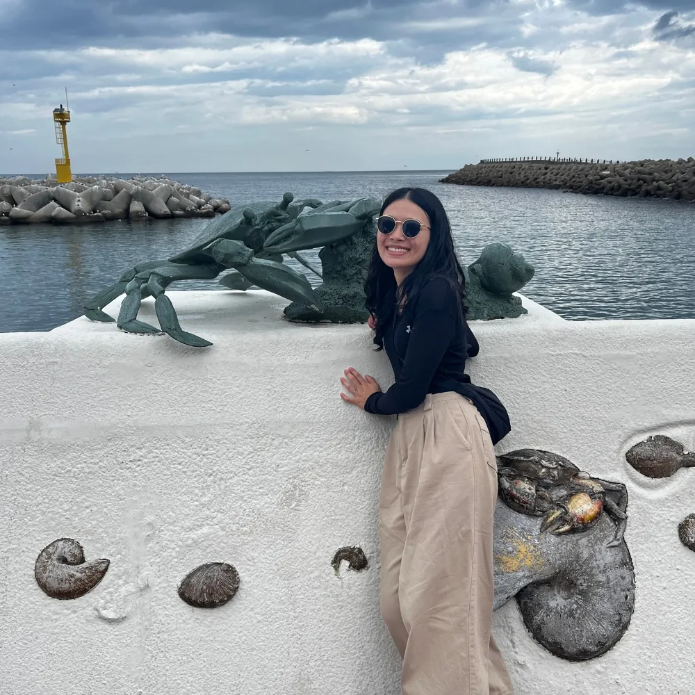 Linda near the ocean sculpture